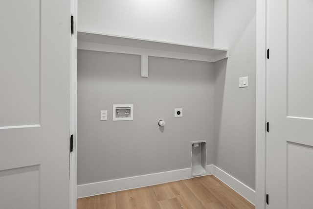 laundry area featuring gas dryer hookup, hookup for a washing machine, laundry area, light wood-style floors, and electric dryer hookup