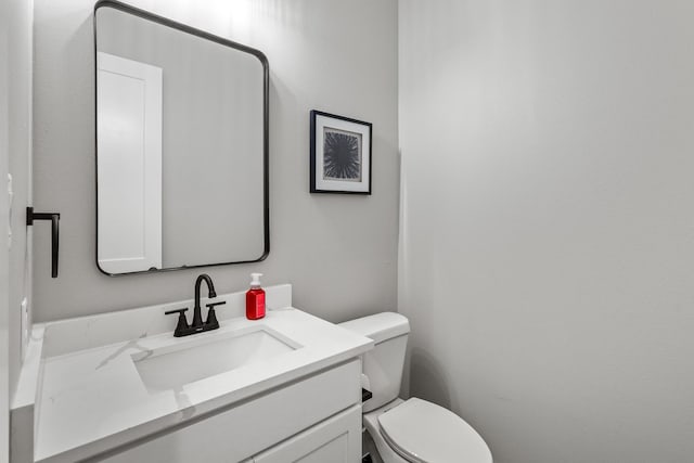 bathroom with toilet and vanity