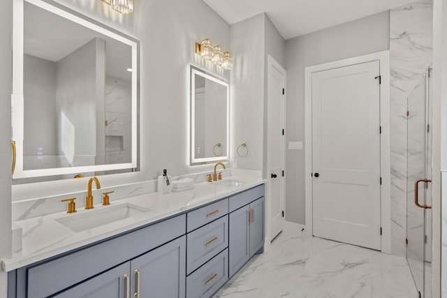 bathroom with double vanity, marble finish floor, a marble finish shower, and a sink