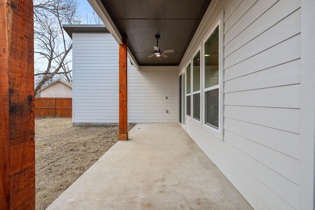 view of patio with fence and a ceiling fan