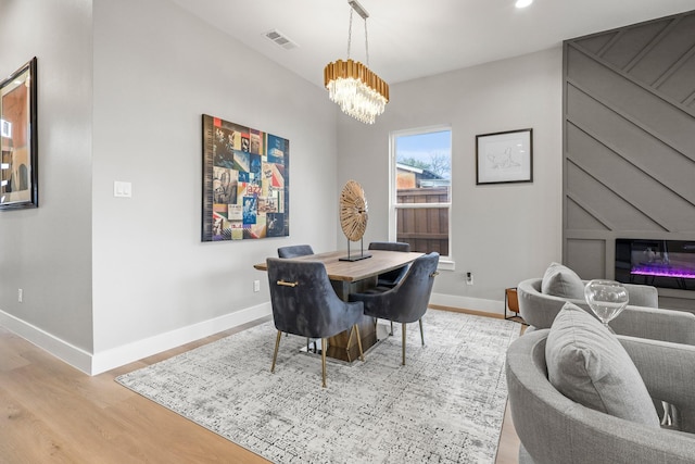 dining area featuring baseboards, visible vents, an inviting chandelier, light wood-type flooring, and recessed lighting