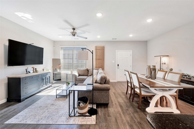 living room with light hardwood / wood-style flooring and ceiling fan