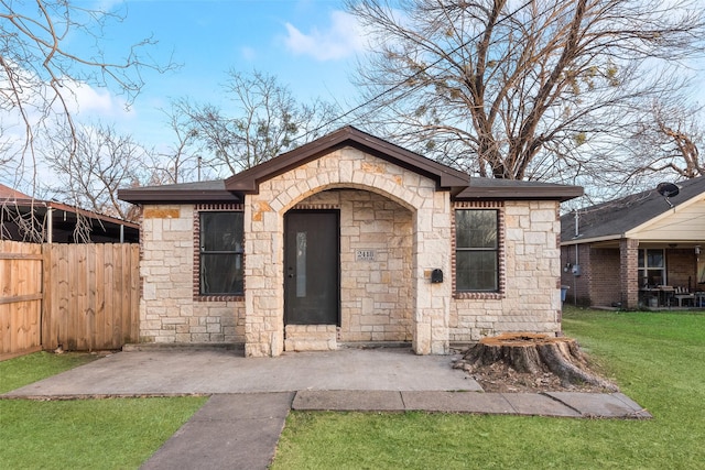 exterior space featuring a front yard and a patio area