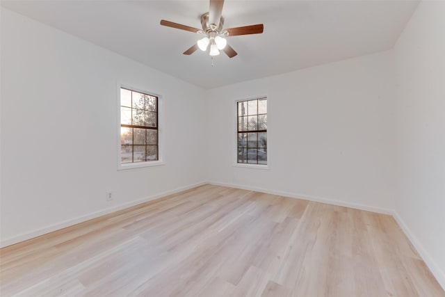 empty room with ceiling fan and light hardwood / wood-style floors