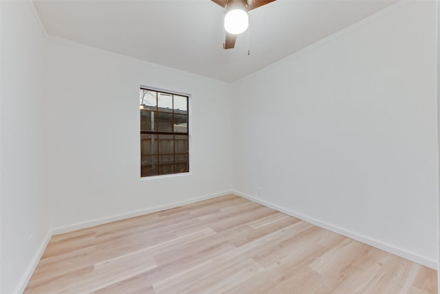 spare room featuring ornamental molding, ceiling fan, and light wood-type flooring