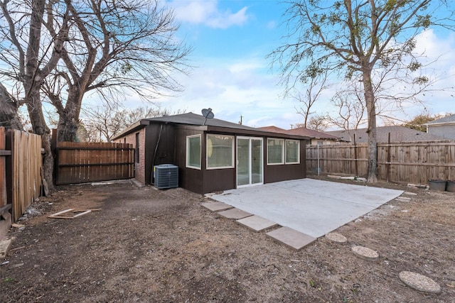 rear view of property featuring central AC and a patio