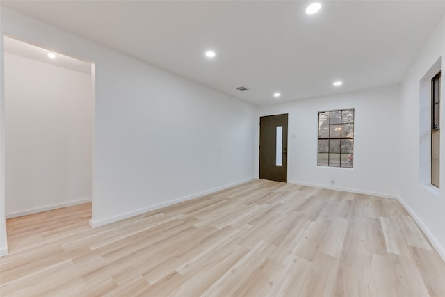 spare room featuring light hardwood / wood-style flooring