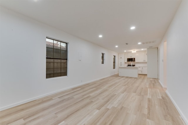 unfurnished living room with light hardwood / wood-style floors