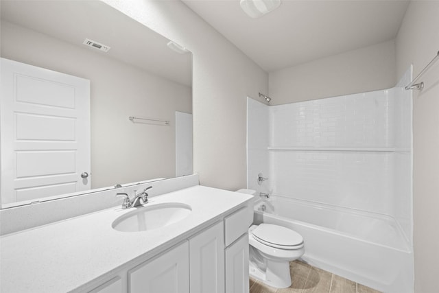 full bathroom featuring visible vents, toilet, tub / shower combination, vanity, and wood finished floors