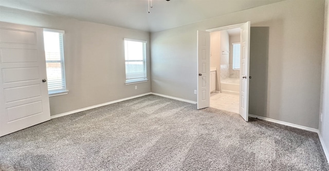 unfurnished room featuring carpet floors, ceiling fan, and baseboards