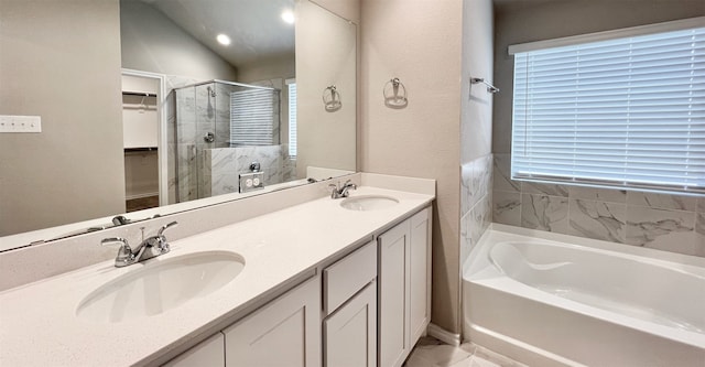 bathroom featuring a garden tub, a shower stall, a spacious closet, and a sink