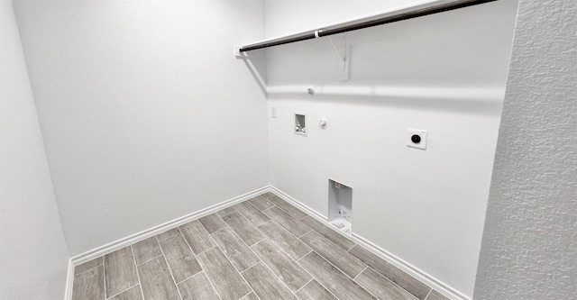 clothes washing area featuring washer hookup, wood finish floors, hookup for a gas dryer, electric dryer hookup, and laundry area