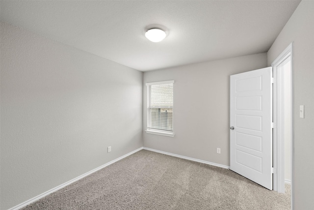 empty room with carpet floors and baseboards