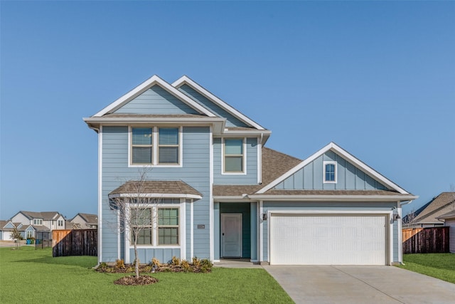 view of front of property featuring driveway, a front lawn, board and batten siding, and fence