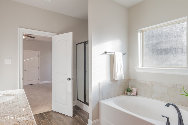 bathroom featuring independent shower and bath and vanity