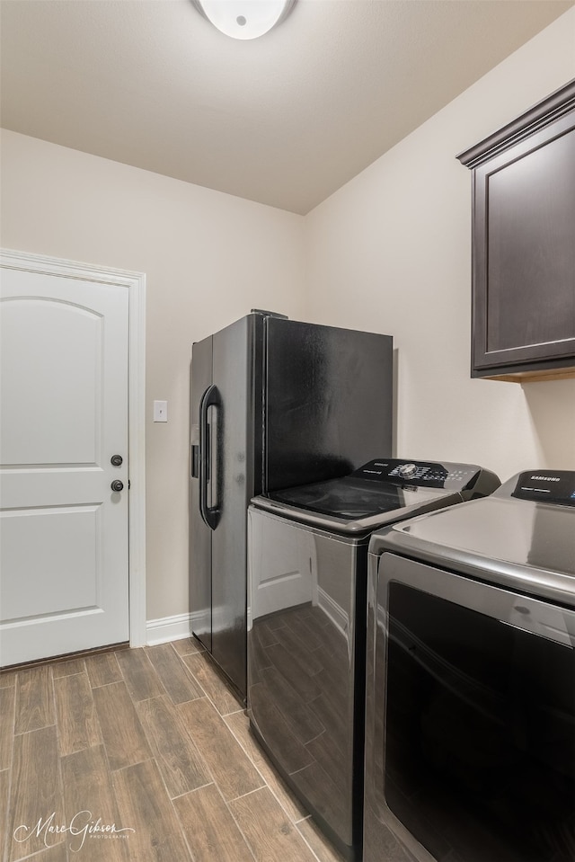 laundry room featuring cabinets and washing machine and dryer