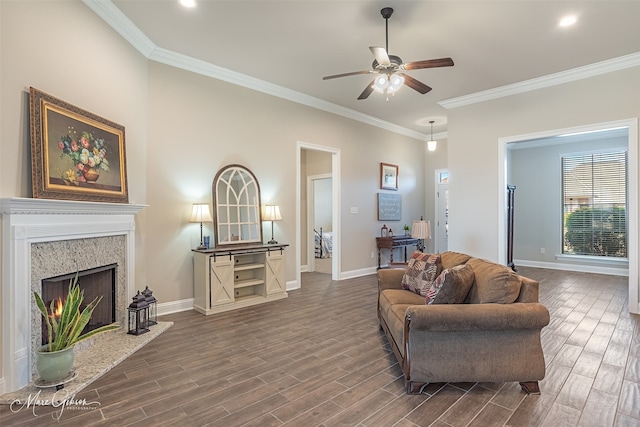 living room featuring ceiling fan, ornamental molding, and a premium fireplace