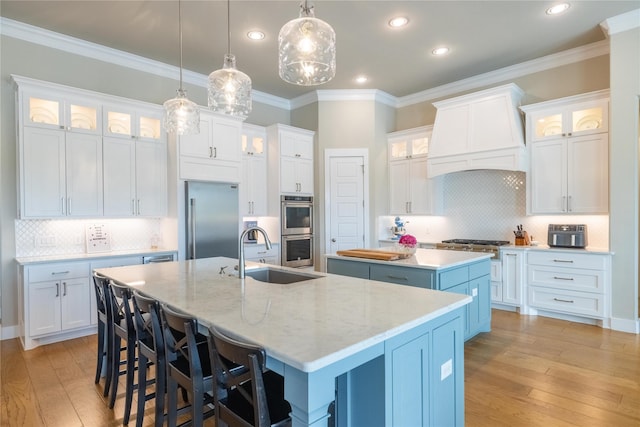 kitchen featuring a spacious island, stainless steel appliances, and white cabinets