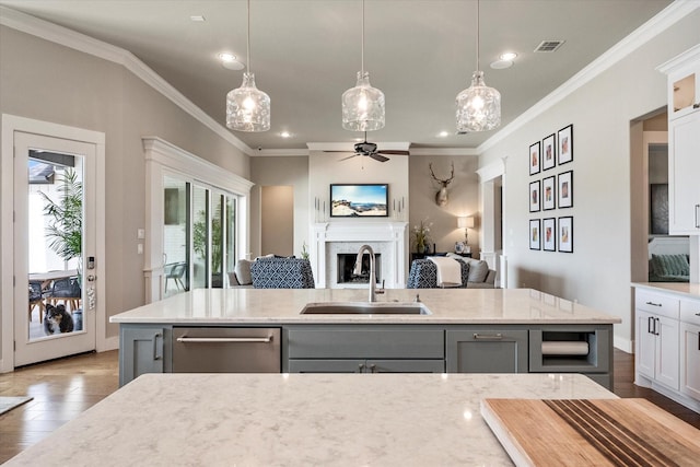 kitchen with open floor plan, a fireplace, a sink, and gray cabinetry