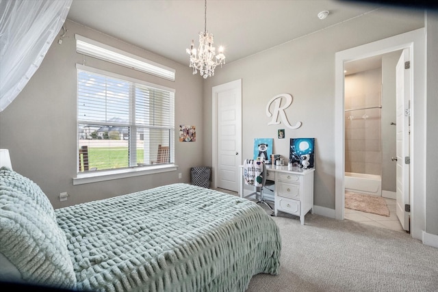 bedroom with light carpet, baseboards, a notable chandelier, and ensuite bathroom