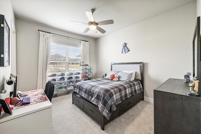 bedroom featuring baseboards, a ceiling fan, and light colored carpet