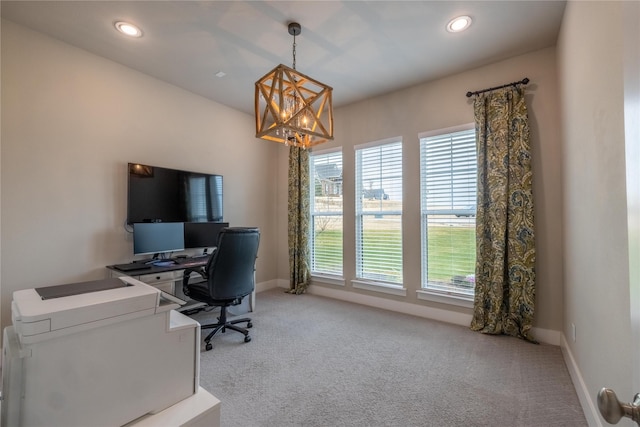 carpeted home office with plenty of natural light and a chandelier