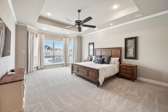 bedroom with light carpet, baseboards, a tray ceiling, and crown molding