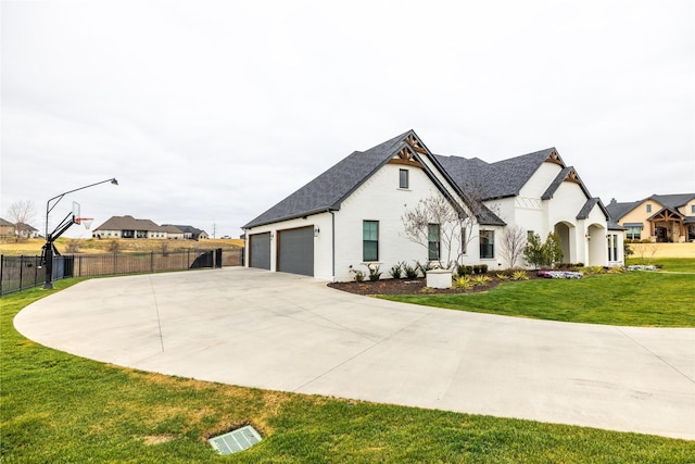 exterior space with a garage and a lawn