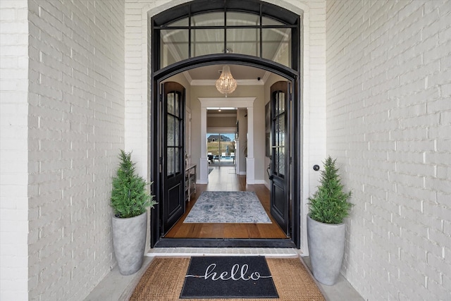 doorway to property featuring brick siding