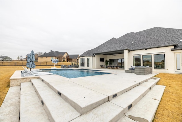 view of swimming pool featuring ceiling fan, a yard, outdoor lounge area, and a patio area