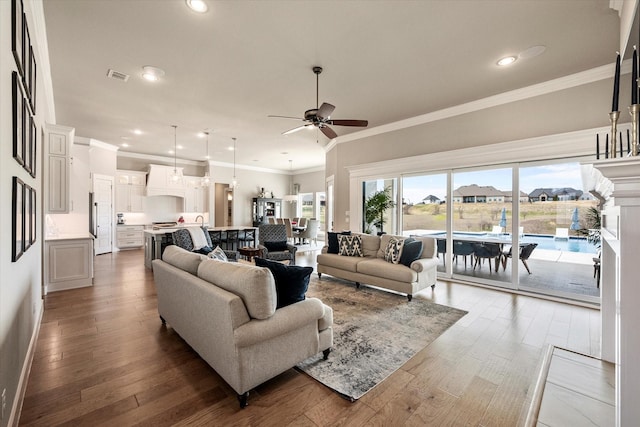 living area with recessed lighting, ceiling fan, and wood finished floors