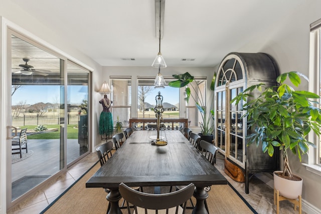 tiled dining room with ceiling fan