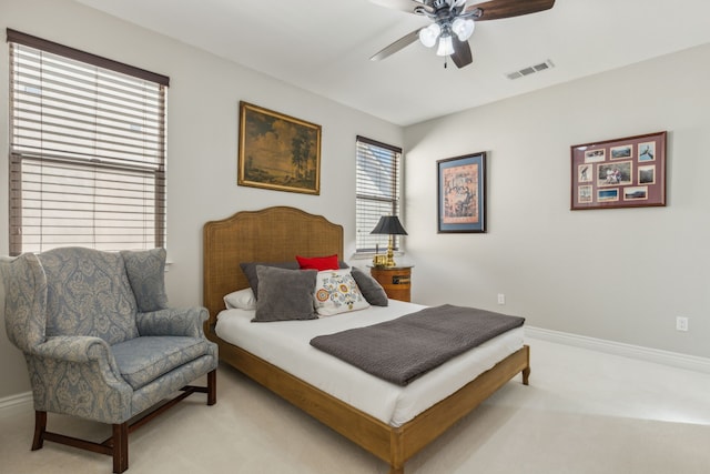 bedroom with ceiling fan and light carpet