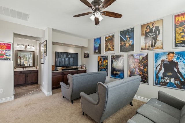 carpeted living room with ceiling fan