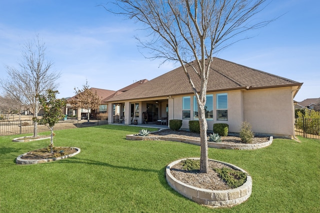 rear view of house featuring a yard and a patio area