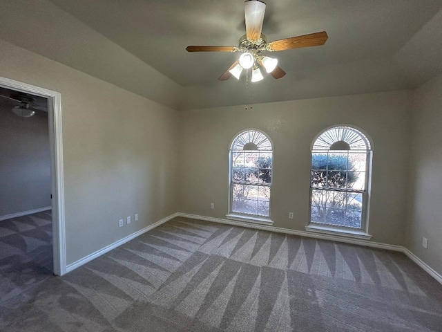 unfurnished room featuring ceiling fan and dark colored carpet