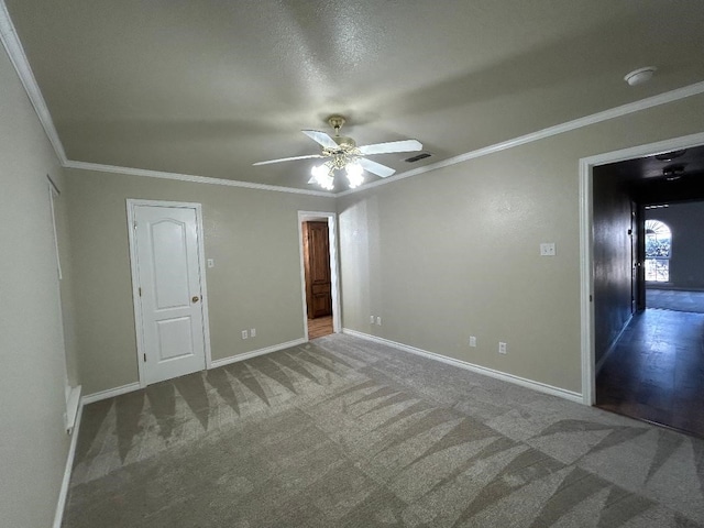 spare room with crown molding, carpet, and ceiling fan