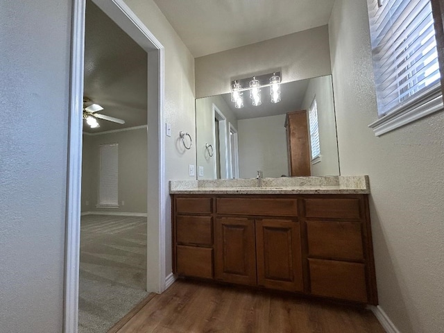 bathroom featuring vanity, hardwood / wood-style floors, and ceiling fan