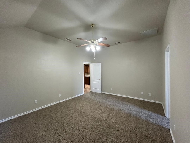 carpeted spare room featuring ceiling fan and vaulted ceiling