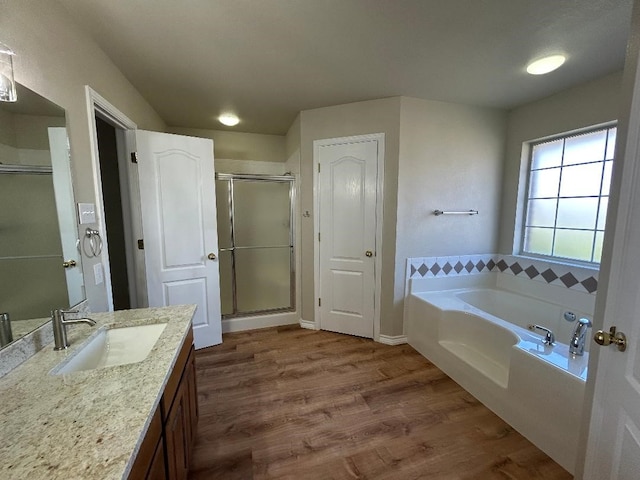 bathroom featuring vanity, hardwood / wood-style floors, and separate shower and tub