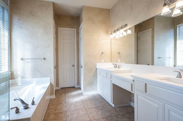 bathroom featuring vanity, a bathtub, a wealth of natural light, and tile patterned floors