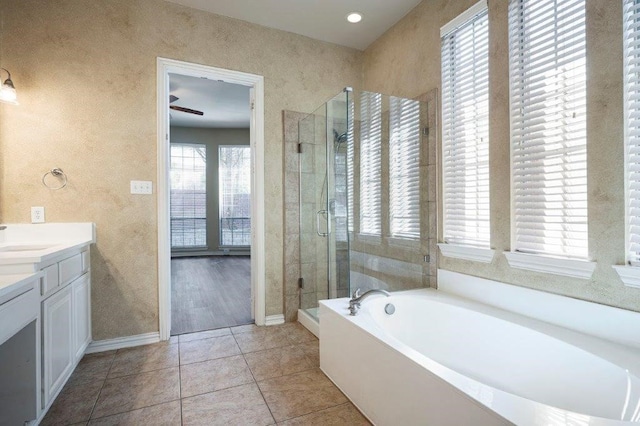 bathroom with vanity, tile patterned floors, and shower with separate bathtub