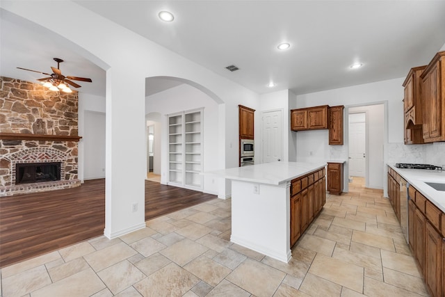 9328 Old Veranda Rd, Plano, TX 75024 - kitchen featuring built in features, ceiling fan, brown cabinetry, light countertops, and recessed lighting