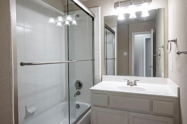 bathroom featuring vanity and bath / shower combo with glass door