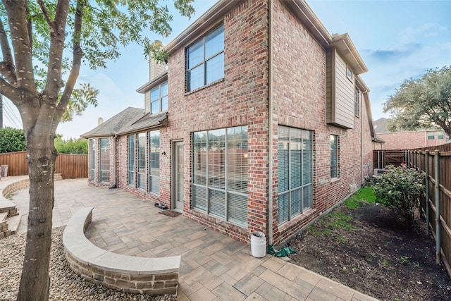 9328 Old Veranda Rd, Plano, TX 75024 - rear view of property with brick siding, a patio, and a fenced backyard