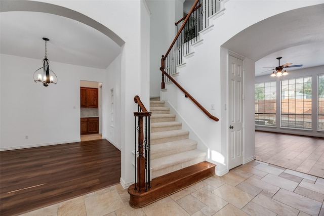9328 Old Veranda Rd, Plano, TX 75024 - stairway featuring arched walkways, a ceiling fan, and baseboards