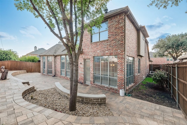 9328 Old Veranda Rd, Plano, TX 75024 - rear view of property with brick siding, a patio area, and a fenced backyard
