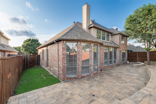 9328 Old Veranda Rd, Plano, TX 75024 - rear view of property with brick siding, a patio area, a fenced backyard, and a chimney