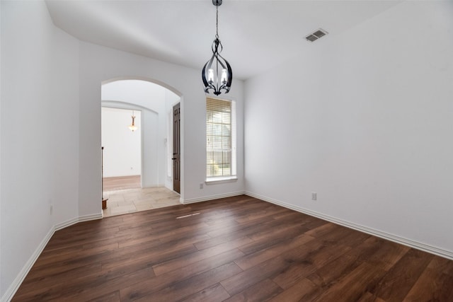 9328 Old Veranda Rd, Plano, TX 75024 - empty room with arched walkways, a chandelier, wood finished floors, and baseboards