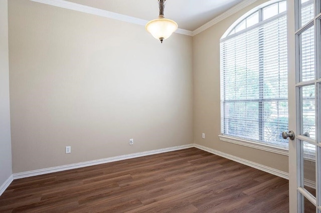 empty room with ornamental molding, plenty of natural light, dark wood-type flooring, and french doors